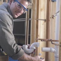 Plumber connecting PVC pipes